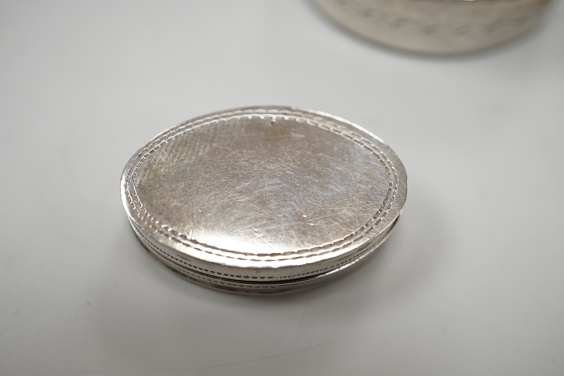 Two George III engraved silver oval patch boxes, largest with hinged cover, Samuel Pemberton, Birmingham, 1818, 28mm, the smaller by John Thornton, Birmingham, 1800.